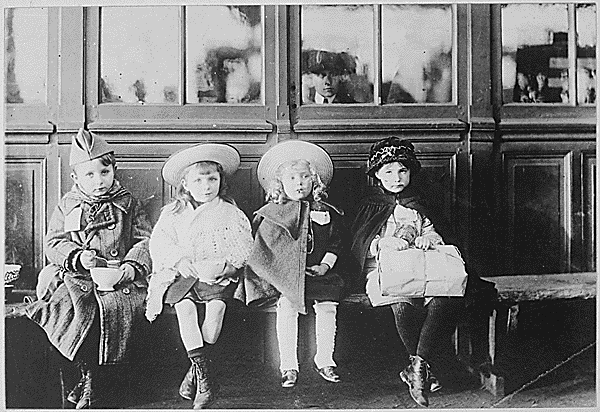French Refugee Children. While waiting for train, children were fed with bread and milk from American Red Cross soldiers canteen. American Red Cross.