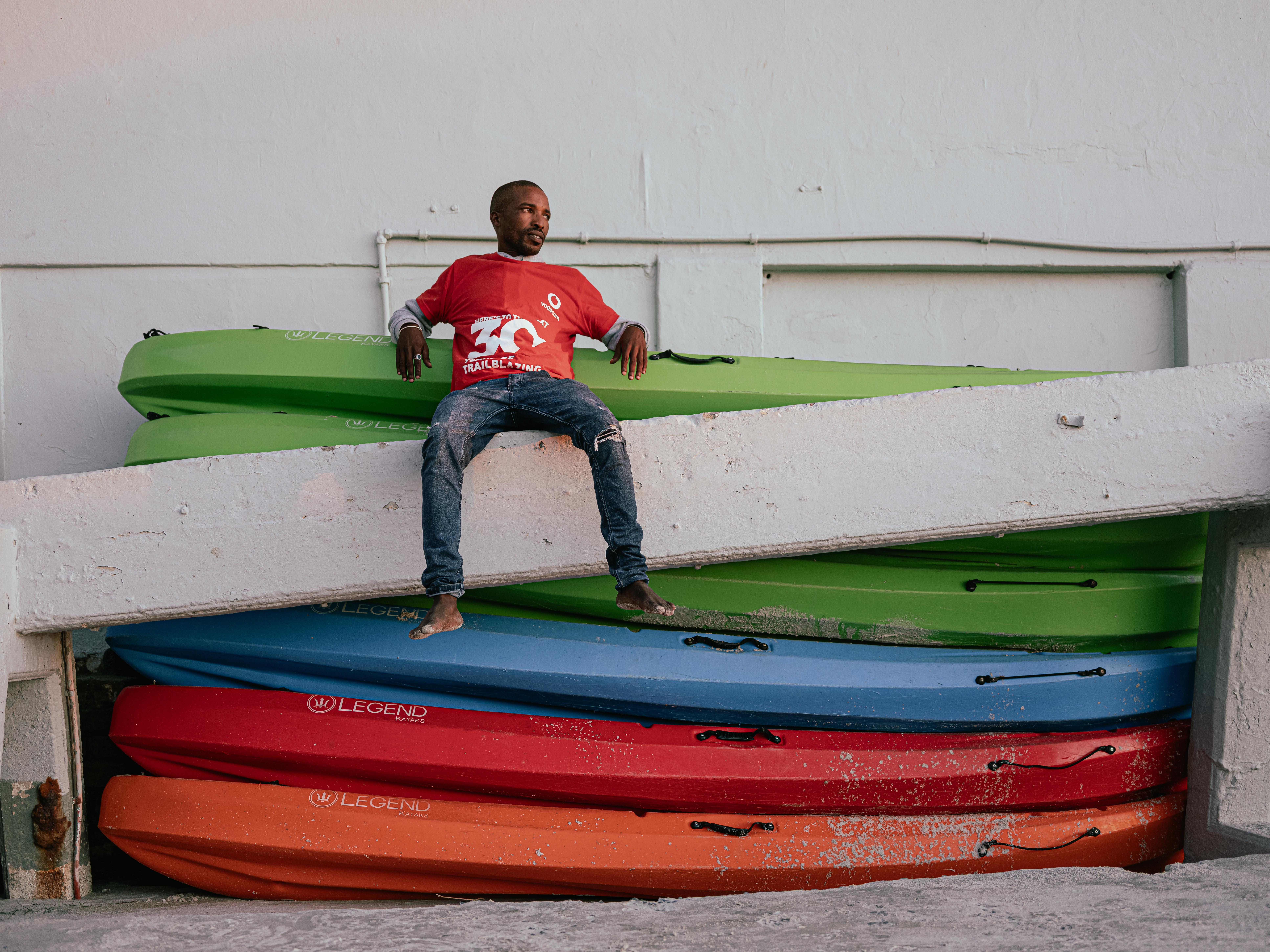 Portrait of a Man and Six Kayaks