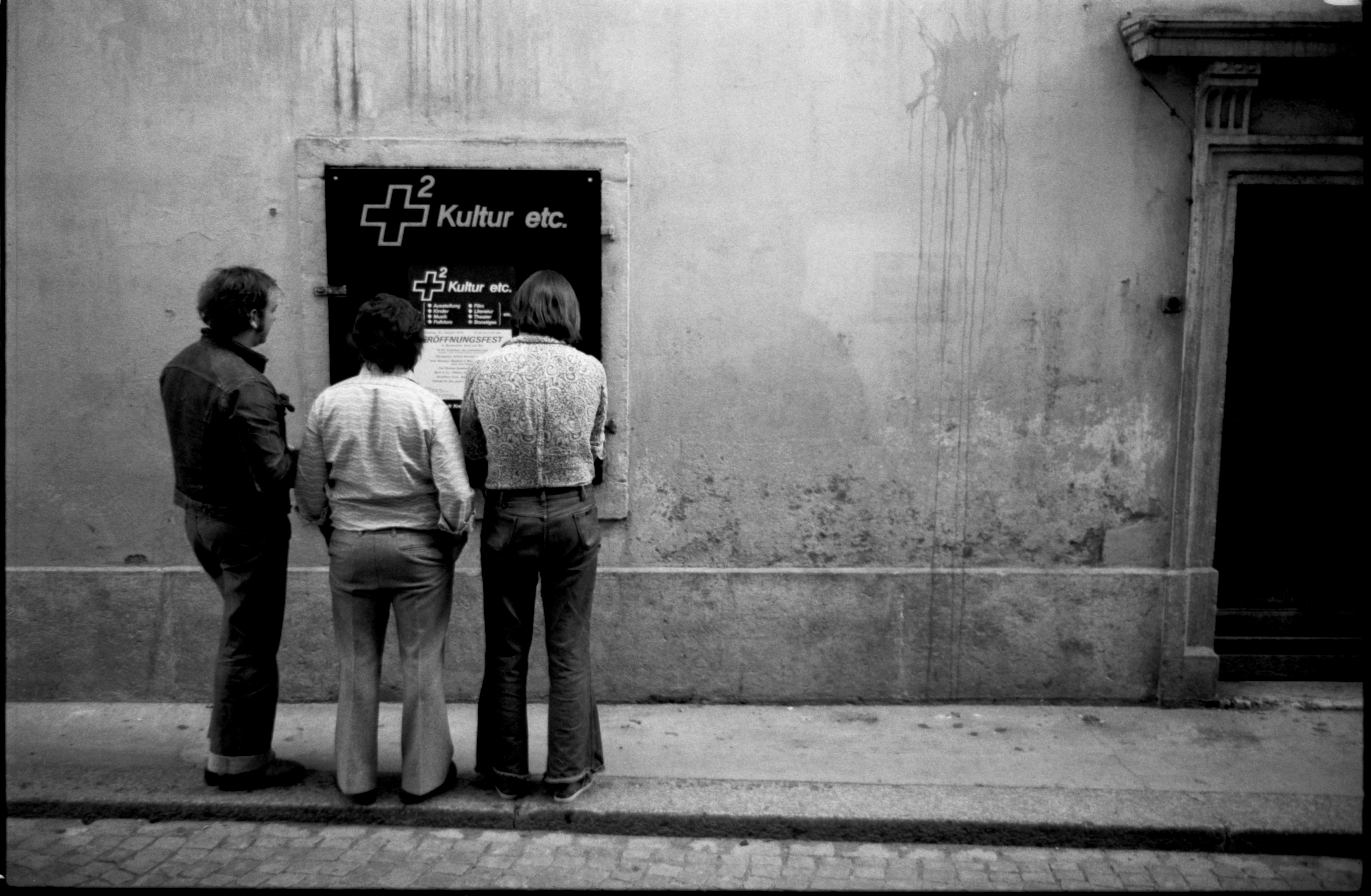 Men Reading a Posted Flyer