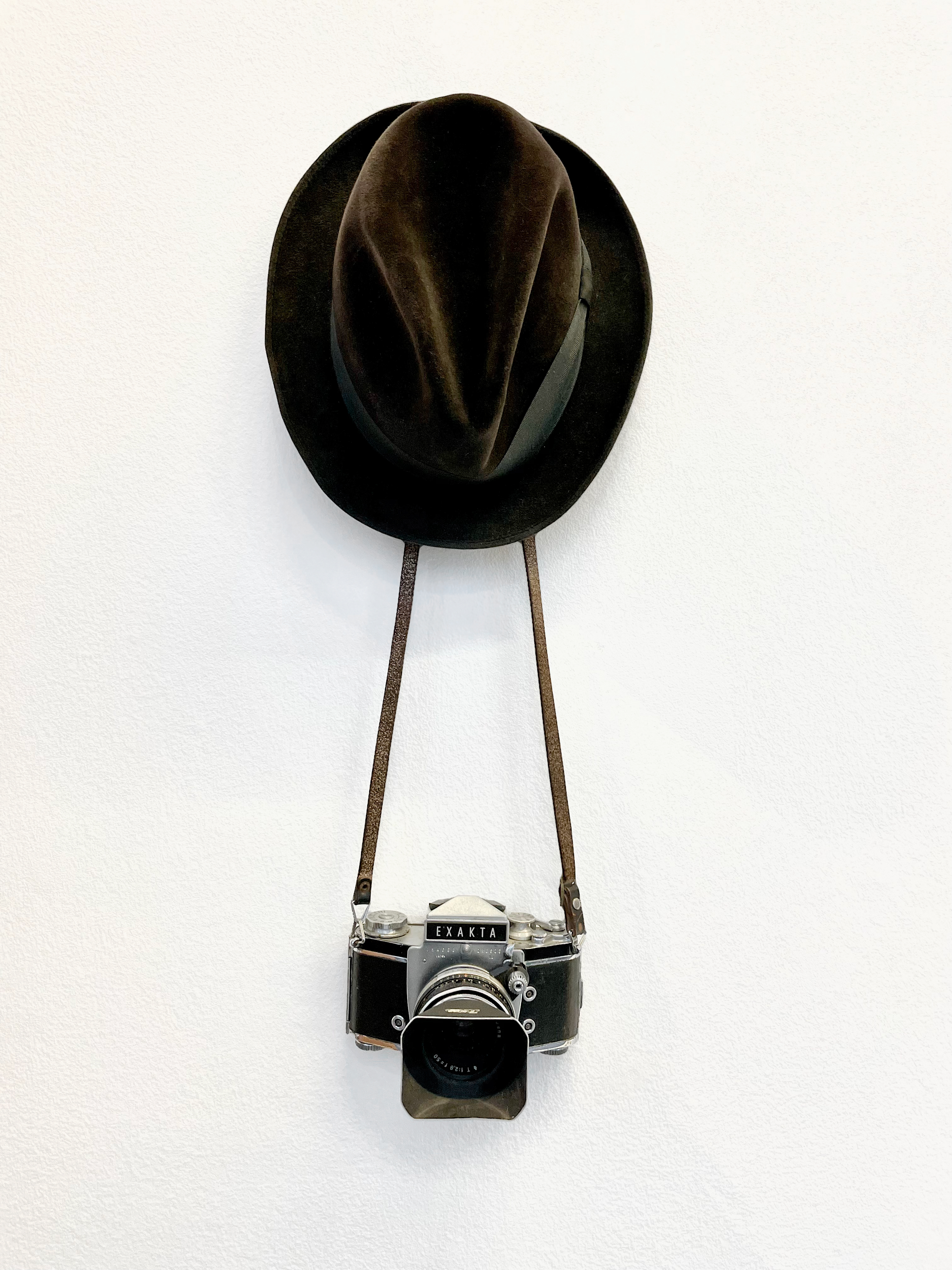 The man with the hat AND a camera.