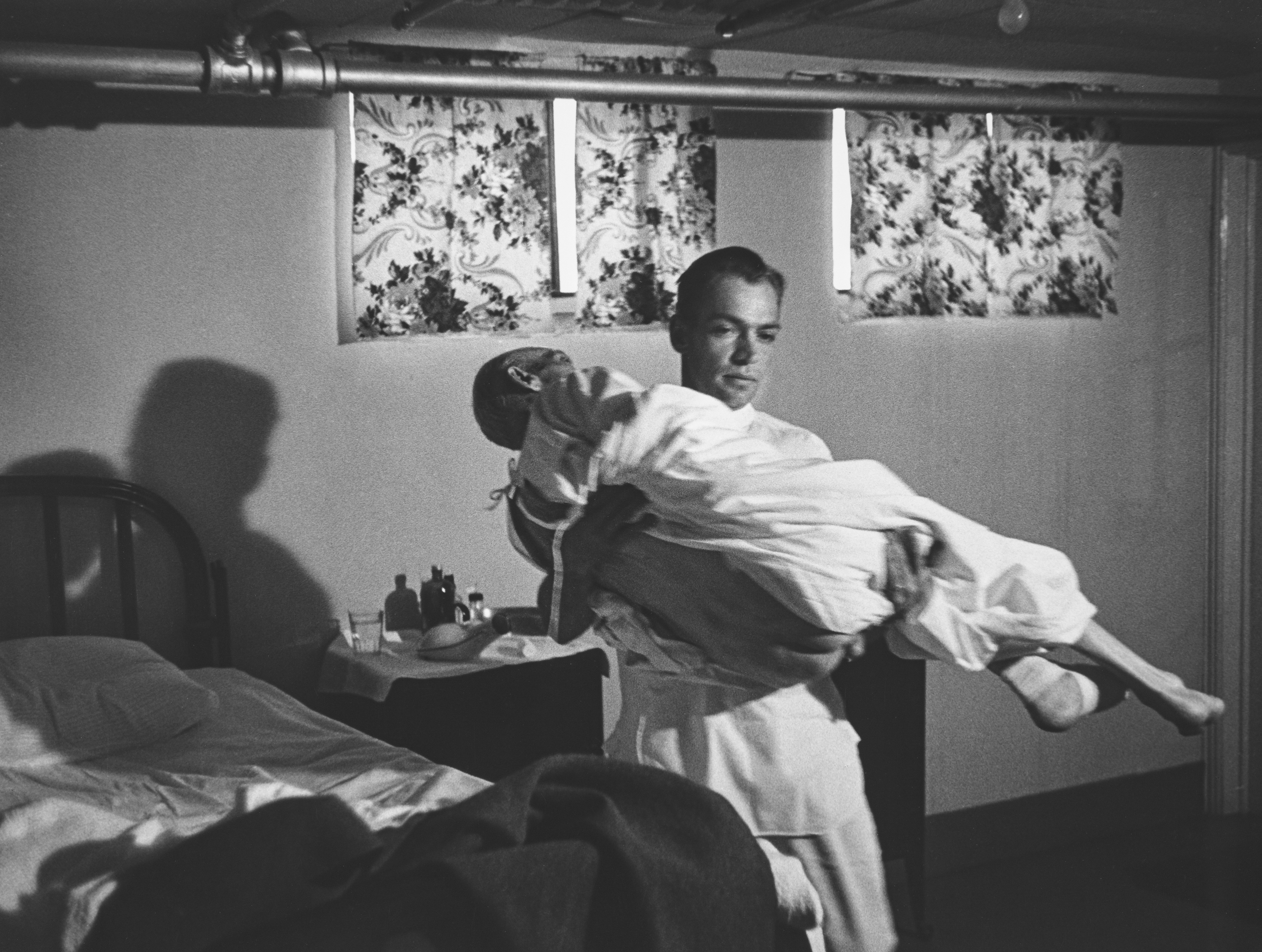 Country Doctor - Dr. Ernest Ceriani Carries Elderly Patient to the Operating Room Because the Hospital Has No Elevator